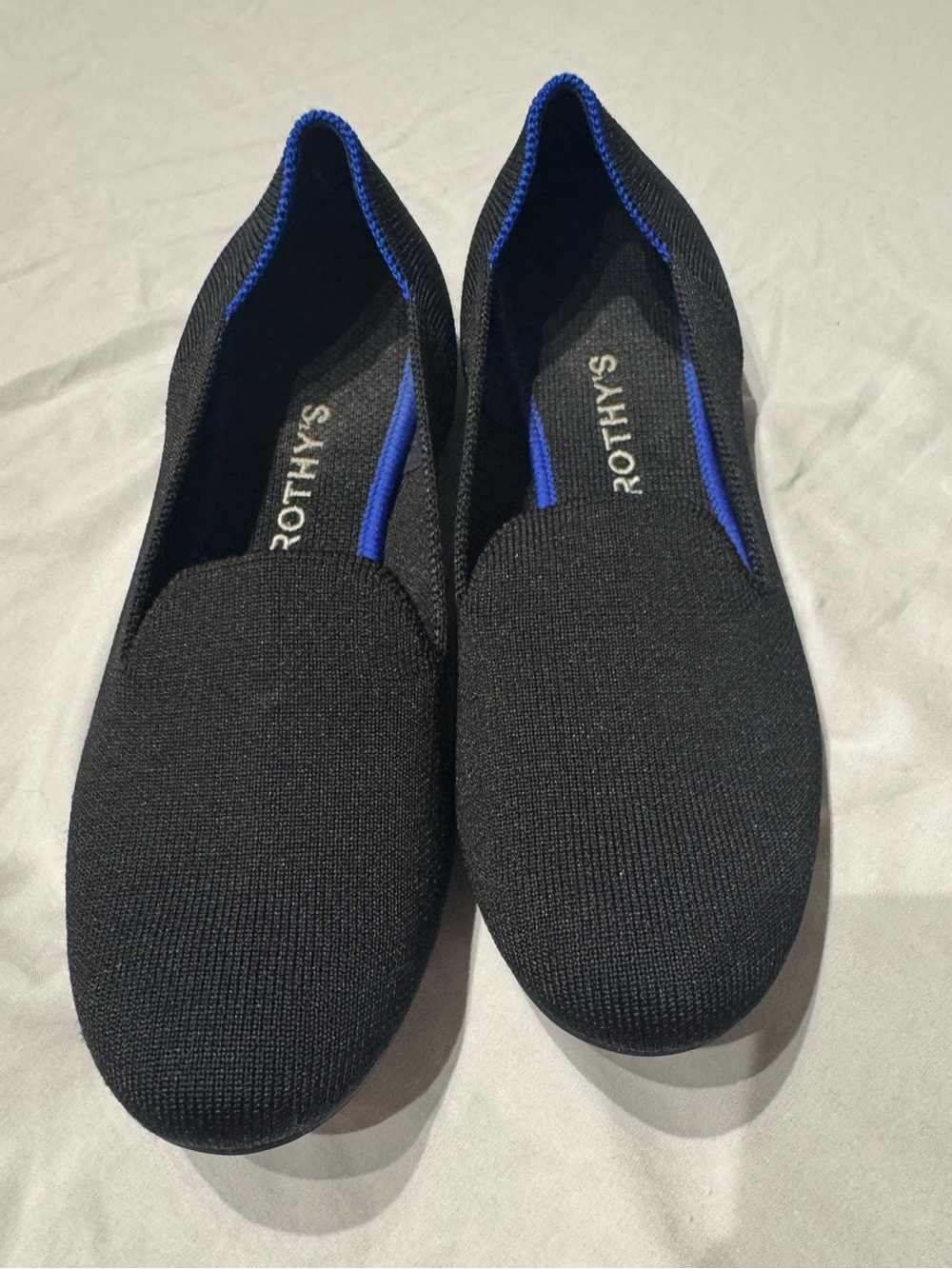 Rothy's Black Slip-On Flats with Blue Accent
